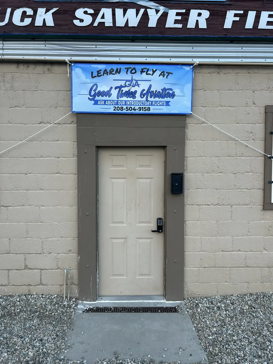 Learn to Fly at Good Times Aviation banner over the door of the Chuck Sawyer Field hangar